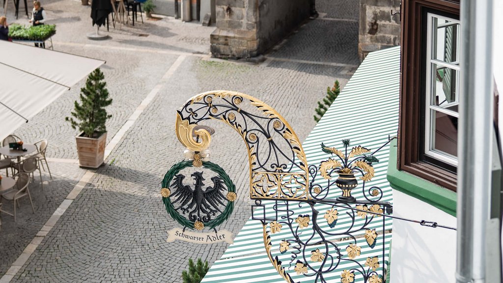 Black Eagle inn sign and outdoor café seating on cobblestone street