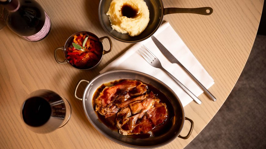 Pamper your palate at this restaurant in Sterzing Plate of meat with sauce, mashed potatoes, vegetables and red wine on wooden table
