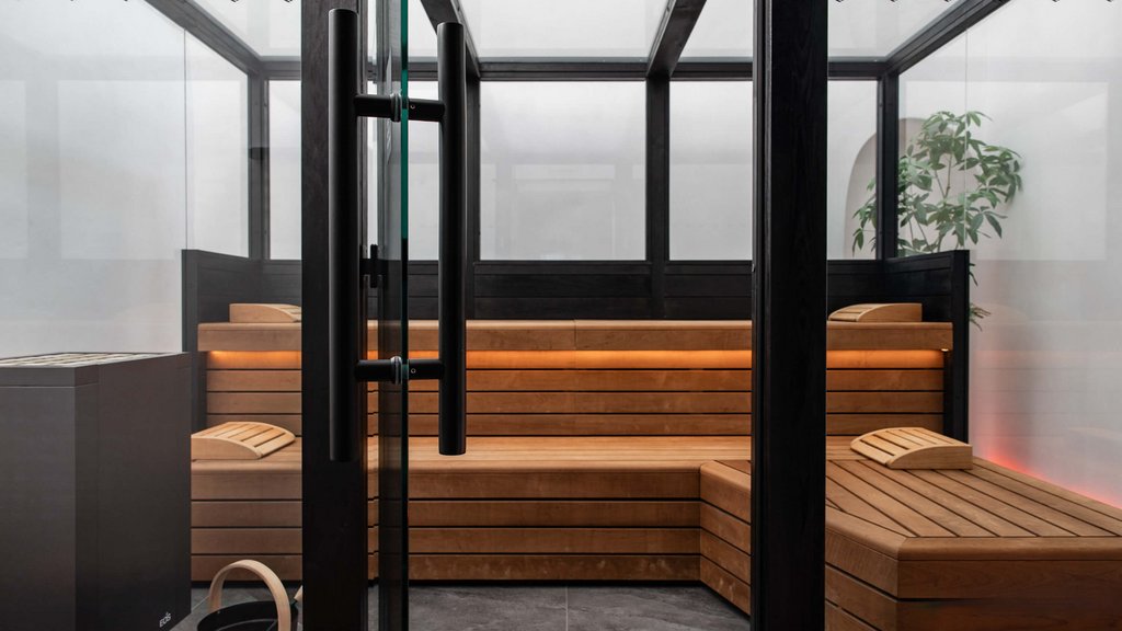 Moderner Saunaraum mit Holzbänken und Glasscheiben