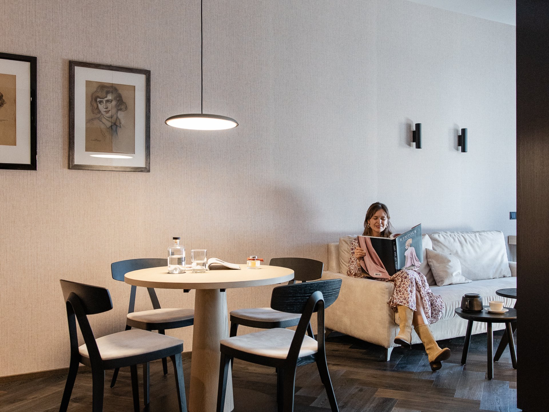 Modern living room with woman reading on the sofa